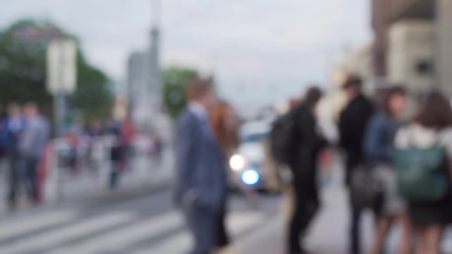 Blurry background of police car with blue lights and people crossing street, beautiful shot