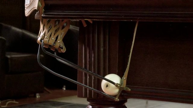Game of billiards. Close-up shot of five white balls falling into pockets on a billiard table. 4K