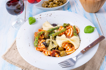 colorful farfalle with green asparagus olives and parma ham