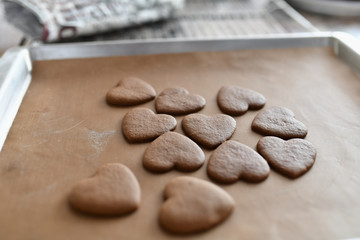chocolate cookies in the form of heart, top view, pastry on the stove, dough preparation