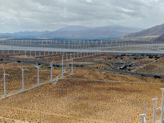 Aerial view of wind turbines generating electricity. Huge array of gigantic wind turbines spreading over the desert in Palm Springs wind farm, California, USA 