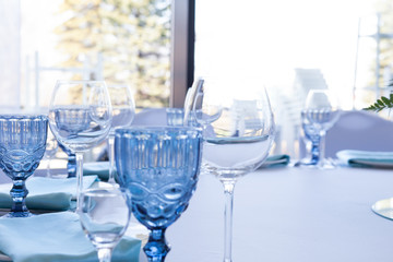 Glasses on the wedding table on a light background