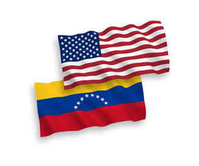 National vector fabric wave flags of Venezuela and USA isolated on white background. 1 to 2 proportion.