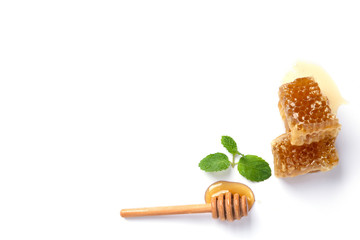 Honey with dipper, honeycomb and mint leaves on white background. Top view or flat lay. Copy space