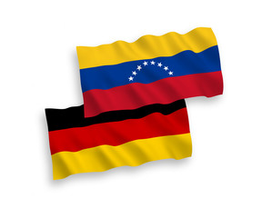 National Vector Fabric Wave Flags of Germany and Venezuela Isolated on White Background. 1 to 2 proportion.