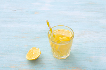 Lemon water in a glass on a white background