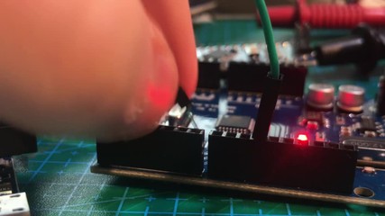 Inserting wires in to arduino pins on workbench while arduino led is flashing.