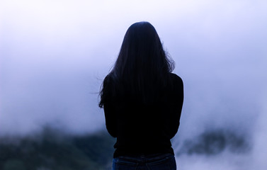  A woman standing alone in the white mist