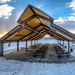 Square Pavilion and playground at a snow covered park during a frosty winter season