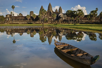 Angkor Wat reflection in lotus pond with boat on evening, Siem Reap, Cambodia