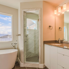Frame Square Modern bathroom interior with double sink vanity glass door shower and bathtub