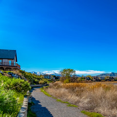 Square Trail in the middle of houses and lake viewed on a bright and sunny day