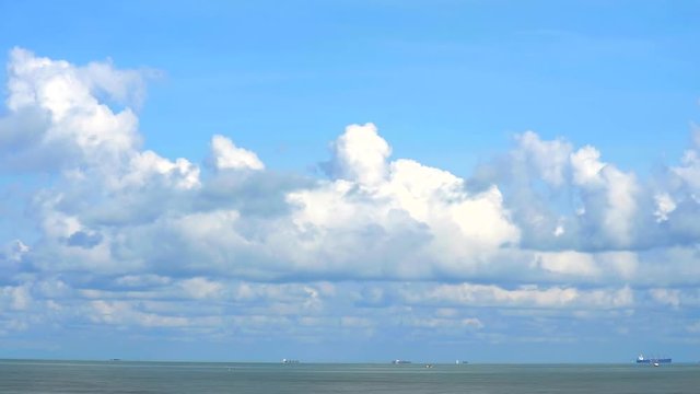 pure blue sky white cloud moving from left to right over sea time lapse