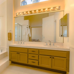 Square Built in bathtub and shower with glass door inside a beautiful bathroom