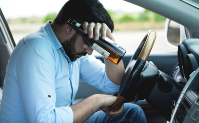 Drunk young man driving a car; sleeping,