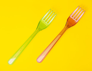 Plastic forks pattern on blue background. Top view, flat lay.