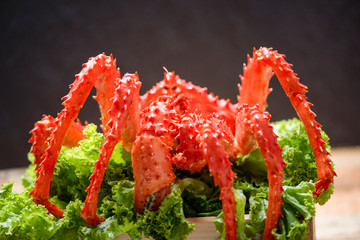 Alaskan King Crab Cooked steam or Boiled seafood and lettuce salad vegetable with dark background red crab hokkaido