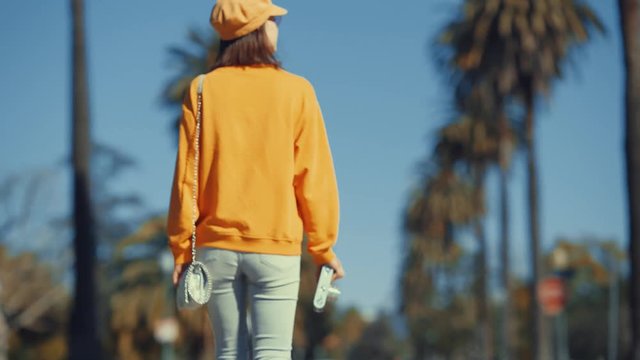 Young girl with a camera walking in Los Angeles