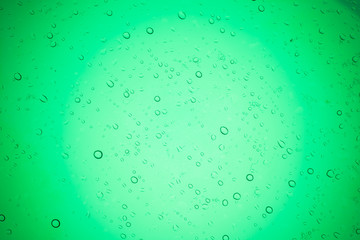 Rain droplets on green glass background, Water drops on glass.