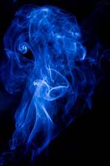 Blue toxic fumes movement on a black background.