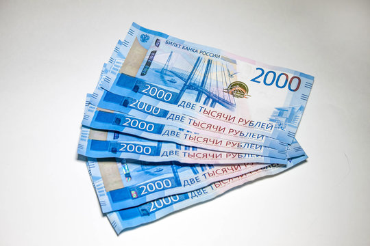Many new banknotes are two thousand Russian rubles. Cash paper money on a white background.