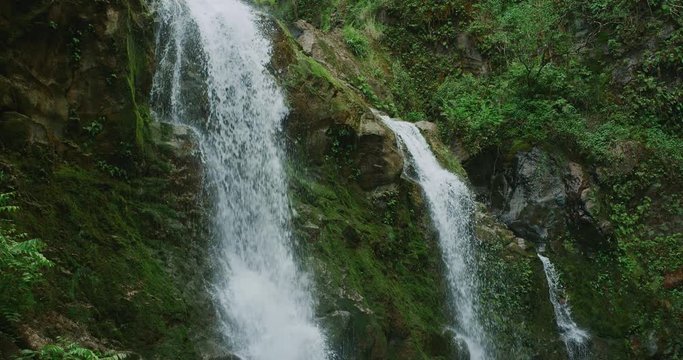 Amazing waterfall in the jungle, three waterfalls flowing in slow motion, jungle adventure vacation