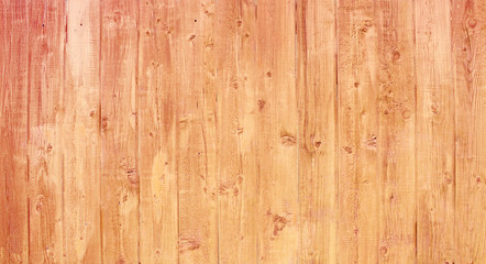 Natural wooden background. Surface of wooden texture for design and decoration. Shabby vertical boards with peeling paint. Brown with a pink shade. Copy space.