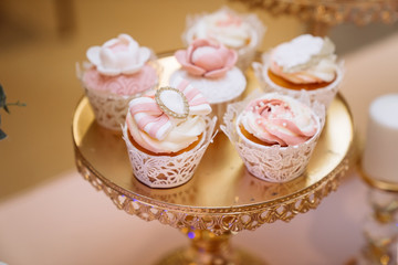 Fototapeta na wymiar Candy bar. Table with sweets, buffet with cupcakes, candies, dessert