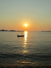 small boat at the sunset