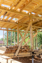 wooden interior frame of a new house under building, architectural residential construction stick built home framework.