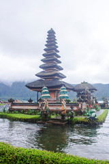 The water temple Pura Ulun Danu Bratan on a foggy day. Lingga Petak Temple in Bali, Indonesia.