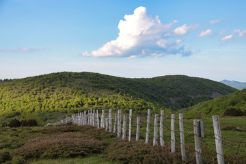 wooden fence with barbed wire on emilia romagna hills