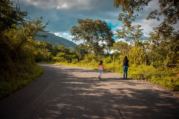 young woman walking on country road