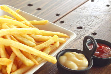 French fries with ketchup and mayonnaise, top view of potato fry.