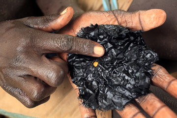 Gold panning, gold and hands at the Bashagi Goldmines near Kibish, Ethiopia, Suri tribe (Surma)