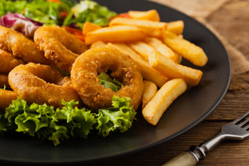 Roasted squid rings with fries.