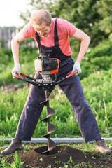 Obraz premium Man plants a tree, hands with shovel digs the ground, nature, ecology concept