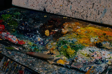 Colourful dried paint on an easel palette