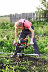 Man plants a tree, hands with shovel digs the ground, nature, ecology concept