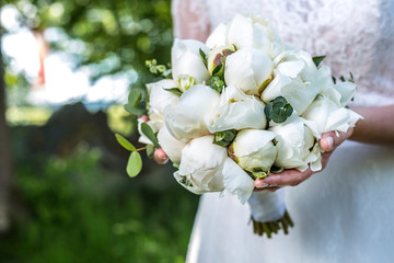 Close up of white wedding bouquet with peonies