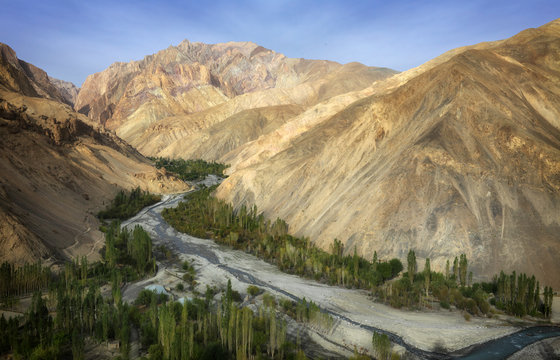 Himalayan mountain range and riverbed in the morning light near Wanla, Ladakh, India