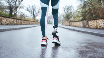 Morning workout. Cropped photo of of disabled athlete woman in sportwear with prosthetic leg...