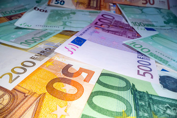 Wide angle view of euro notes background stacked on top of each other. Euro money banknotes, pile of money, cash, stack of bills. Investing money, savings