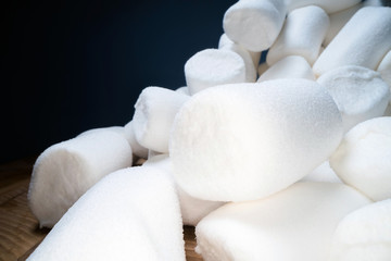 Pile of sweet and soft marshmallow. Yummy white sweets on dark background, fast food