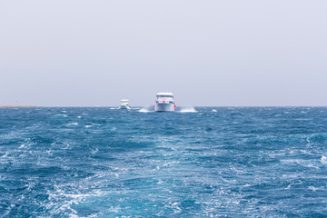 Boat Wave ocean trace on blue sea fresh water background.