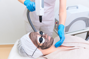Procedure carbon facial peeling in the clinic of laser cosmetology.