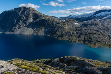 Fototapeta na wymiar The blue water of Djupvatnet lake, a mountain lake in Norway