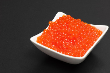 Red caviar in a saucer