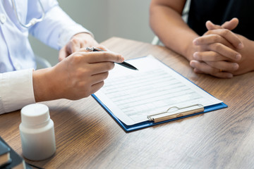 Doctor explaining and giving a consultation to a patient medical informations and diagnosis about the treatment for condition in hospital, medical ethics concept.
