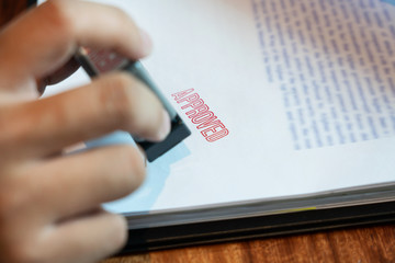 businessman Hand notary public hand ink appoval stamper Stamping seal On Approved Contract Form...